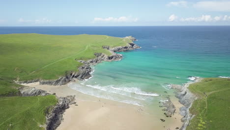 Picturesque-Landscape-Of-Calm-Blue-Sea,-Kelsey-Head,-West-Pentire-Peninsula-From-Poly-Joke-Beach-In-England,-UK