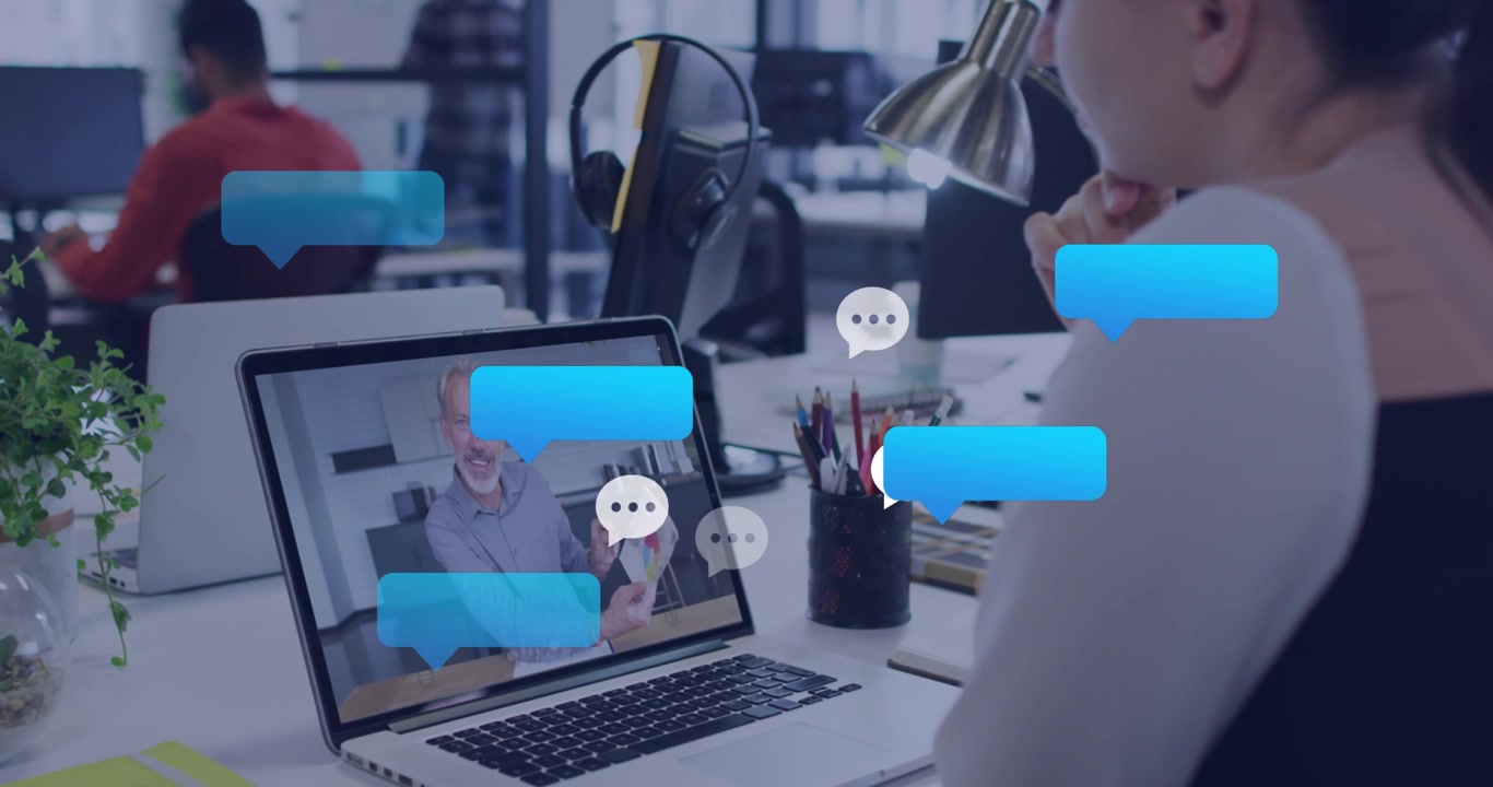 Animazione di icone dei social media su una donna caucasica in videochiamata sul laptop in ufficio.