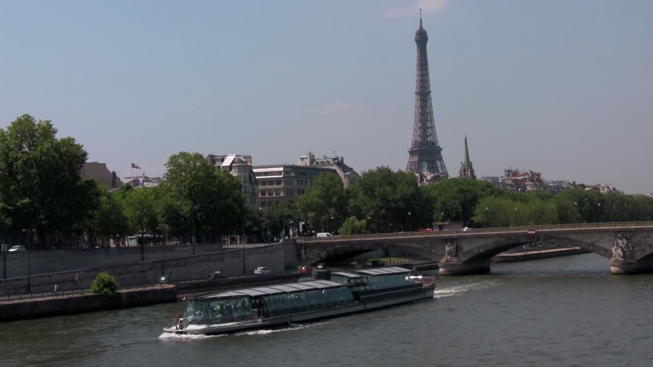 The Seine and the Eiffel Tower with riverboats in Paris France