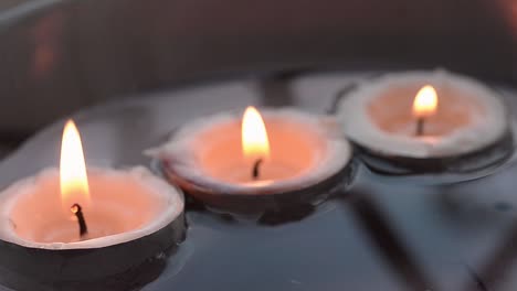 candles floating in water