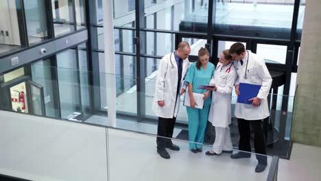 doctors interacting with each other in corridor