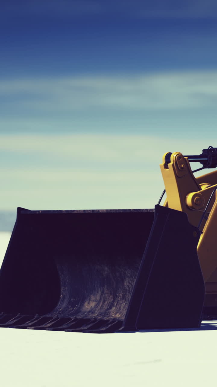 Heavy machinery works on snow removal during winter season in a rural area
