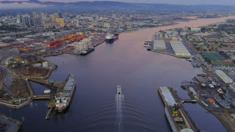 The-San-Francisco-and-Alameda-Ferry-at-the-Port-of-Oakland-during-a-romantic-sunset---aerial-tilt-up-reveal