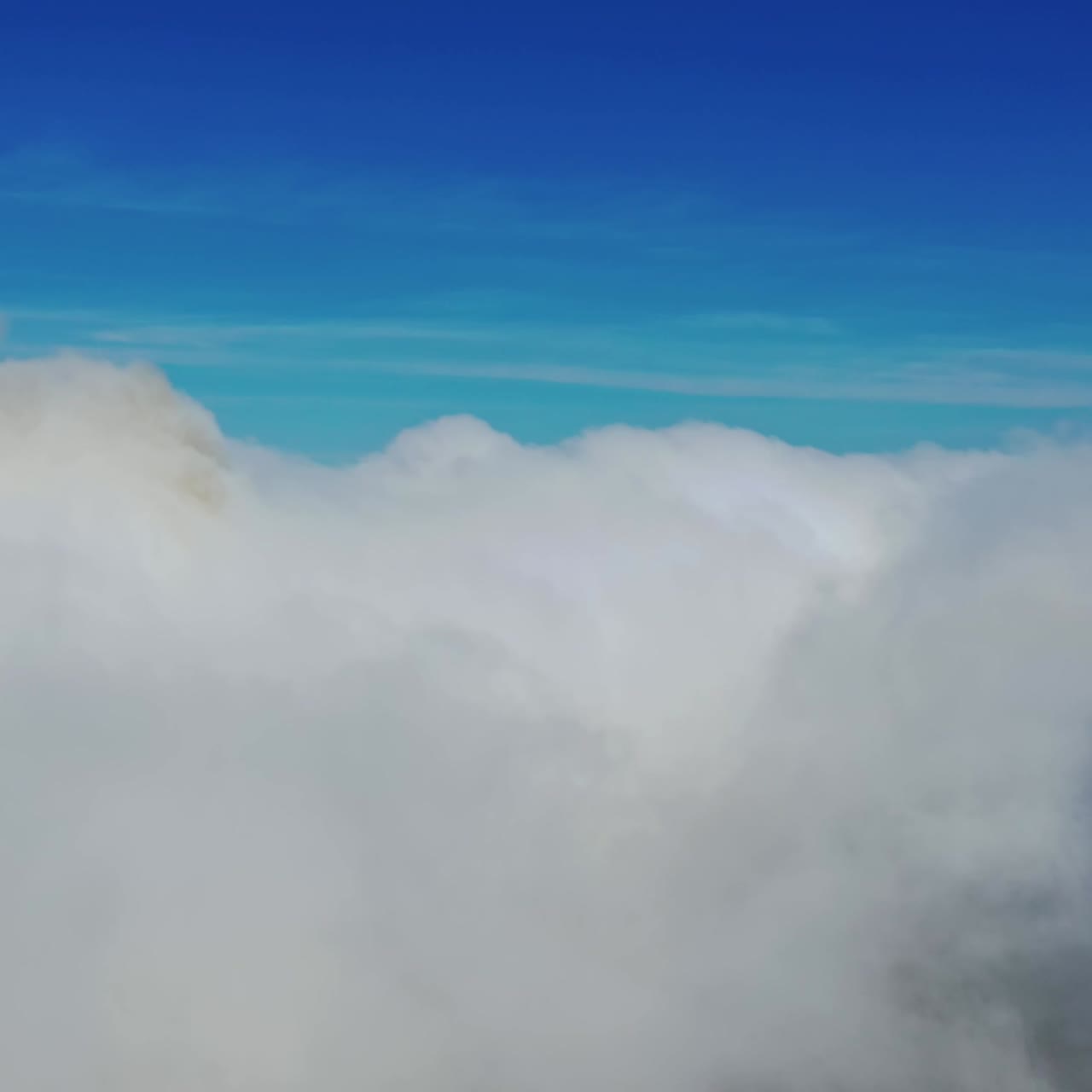 Scenic view of beautiful sky. Flying among soft white clouds moving on blue sky. High in blue sky through the fluffy clouds.