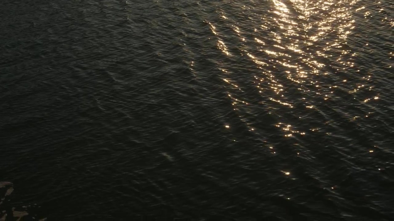 Sunlight Reflecting On Rippling Water At Sunset In Ha Long Bay, Vietnam. High angle shot