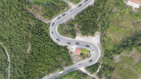 ascenso aéreo sobre las montañas albanesas carretera serpentina con intenso tráfico