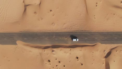 aerial view of a car on a road in the desert