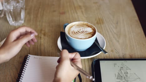 architect woman working in cafe drinking coffee high angle