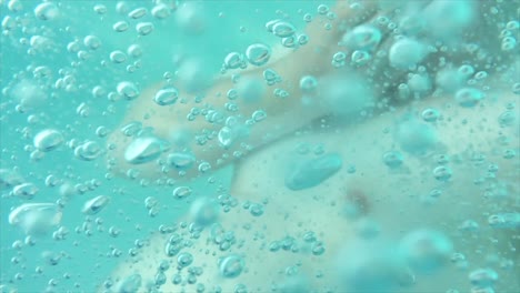 bubbles floating around a man’s body under water