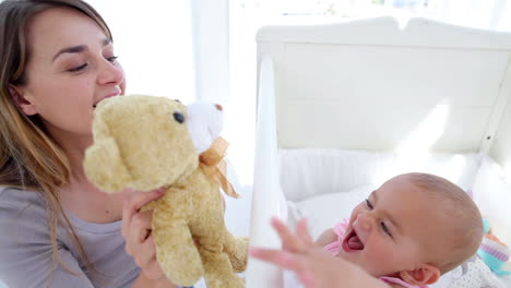 baby girl kissing her teddy bear