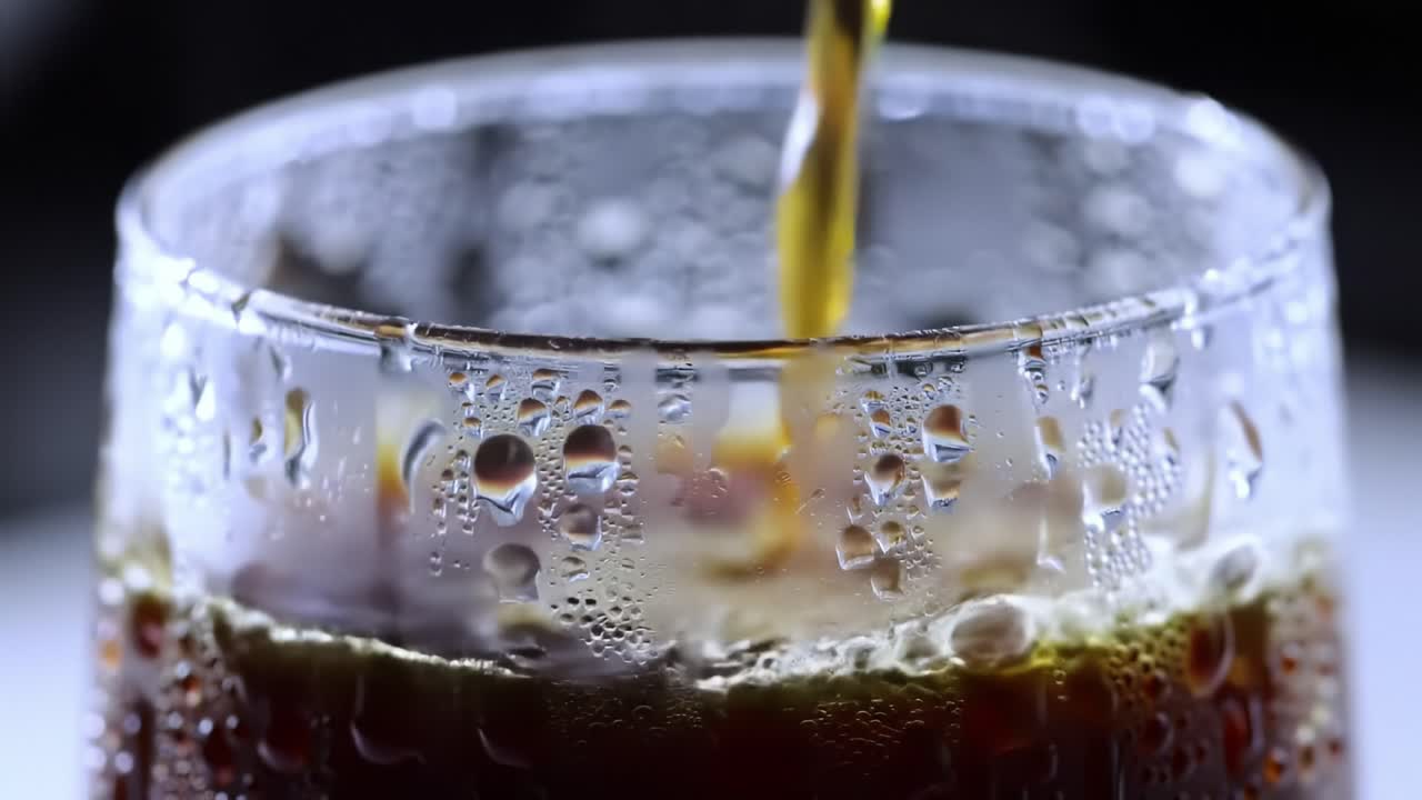 An Intriguing Journey of Refreshment: A Close-Up Look at a Frosted Glass Filled with Refreshing Beverage and Refreshing Condensation Capturing Moments of Enjoyment