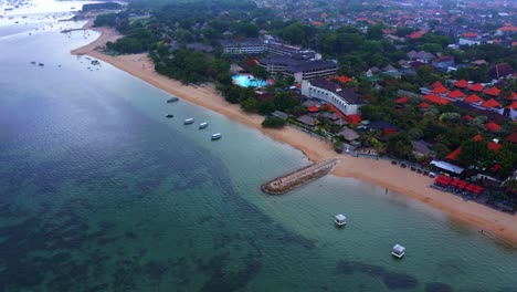 aerial drone view of beachfront town hotels and accommodations in sanur, bali indonesia