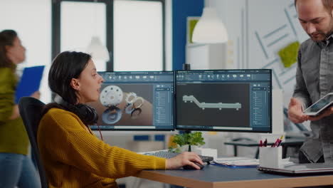 industrial designer holding tablet discussing with woman engineer