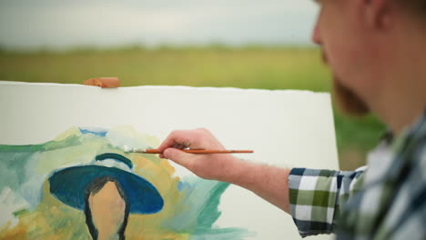 un artesano, parcialmente visible, con una camisa a cuadros, sostiene hábilmente un pincel y una paleta mientras aplica trazos vibrantes a un lienzo. enfoque y técnica a medida que dan vida a la obra de arte