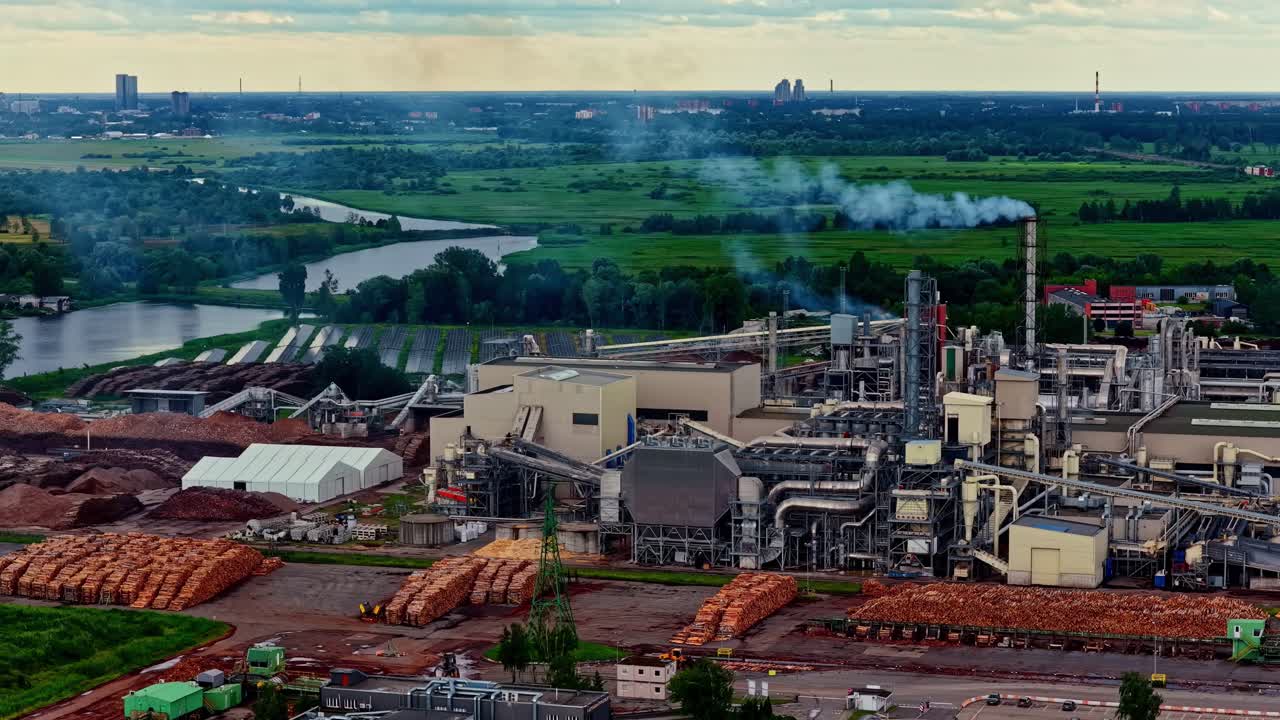 Aerial view of a large industrial factory with smoke from the chimney