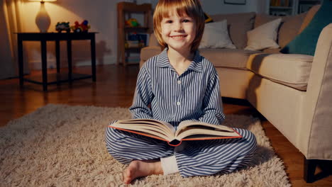 child reading a book in pajamas