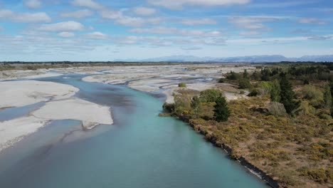 aerial reverse downstream above beautiful turquoise-colored waimakariri river as main channel widens