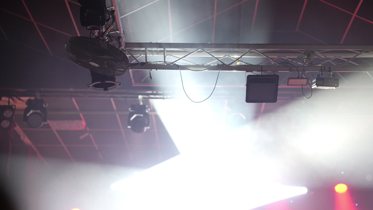 Red concert lights and stage rigging above