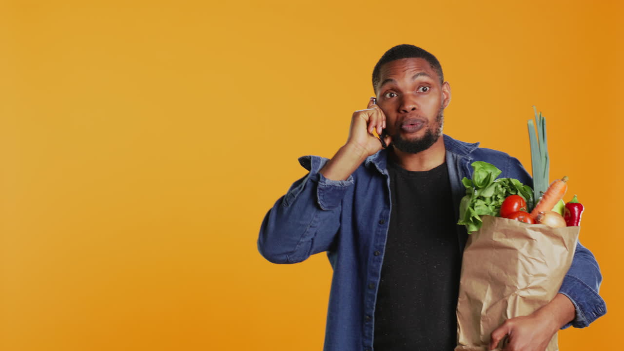 African american man on grocery shopping spree chatting on phone call