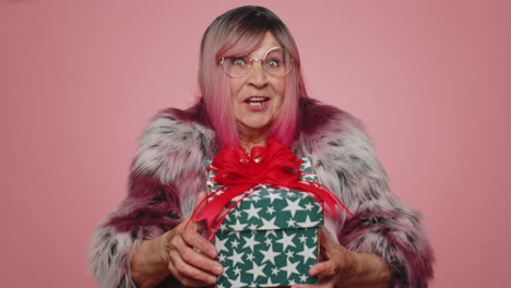 smiling woman presenting birthday gift box stretches out hands, offer wrapped present career bonus