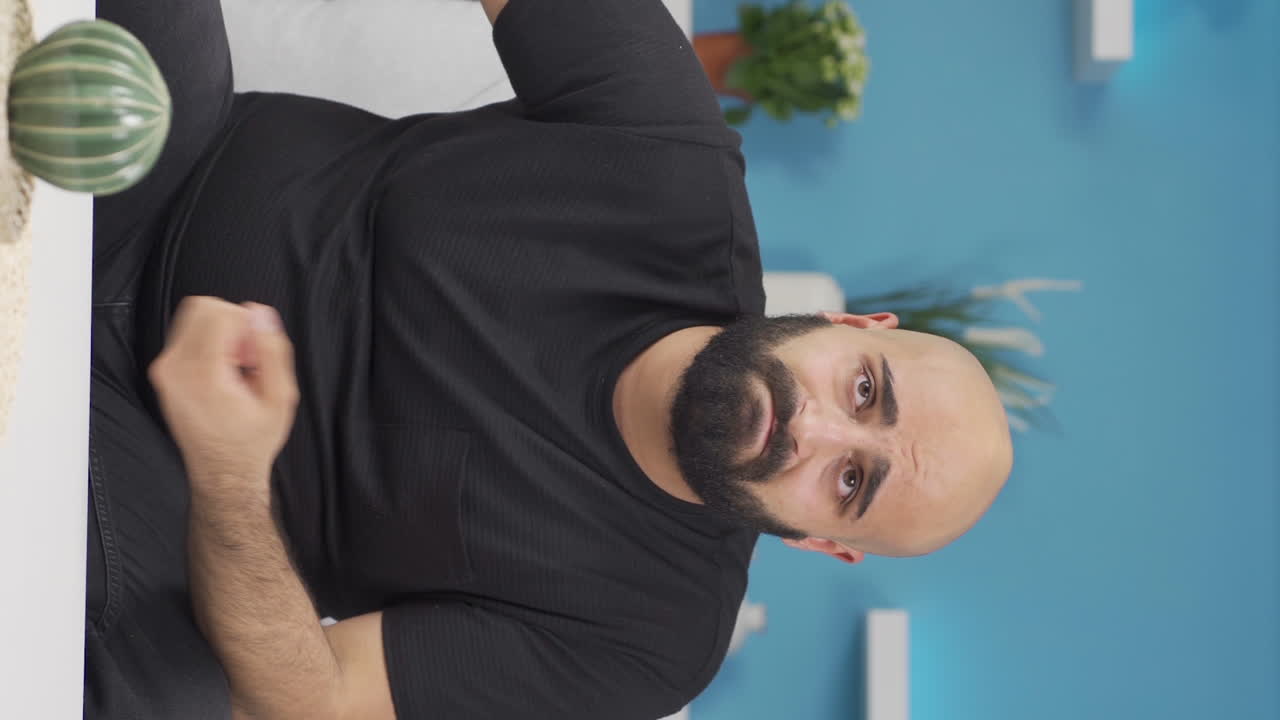 Vertical video of Unhappy thinking man.