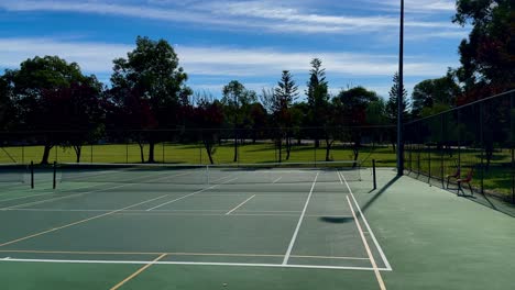 tennis court wide net green turf blue sky perth australia