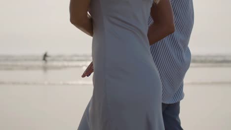 closeup of romantic caucasian couple walking along the beach.