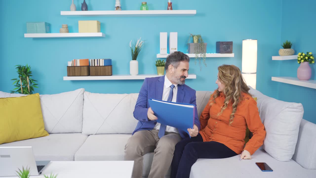 el hombre de negocios, que vuelve a casa con gran alegría, celebra su éxito con su esposa.