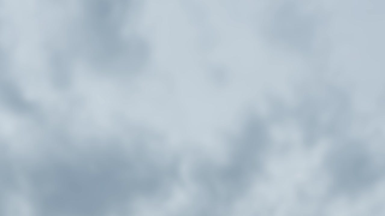 Gray storm clouds drift rapidly across the sky in a smooth timelapse, soft natural lighting