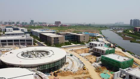 weihai olympic center hotel section construction aerial forward rotating dolly - nanhai new district, china