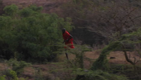 a man is running through a wooded area