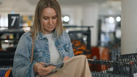 pretty woman chooses clothes in a store.