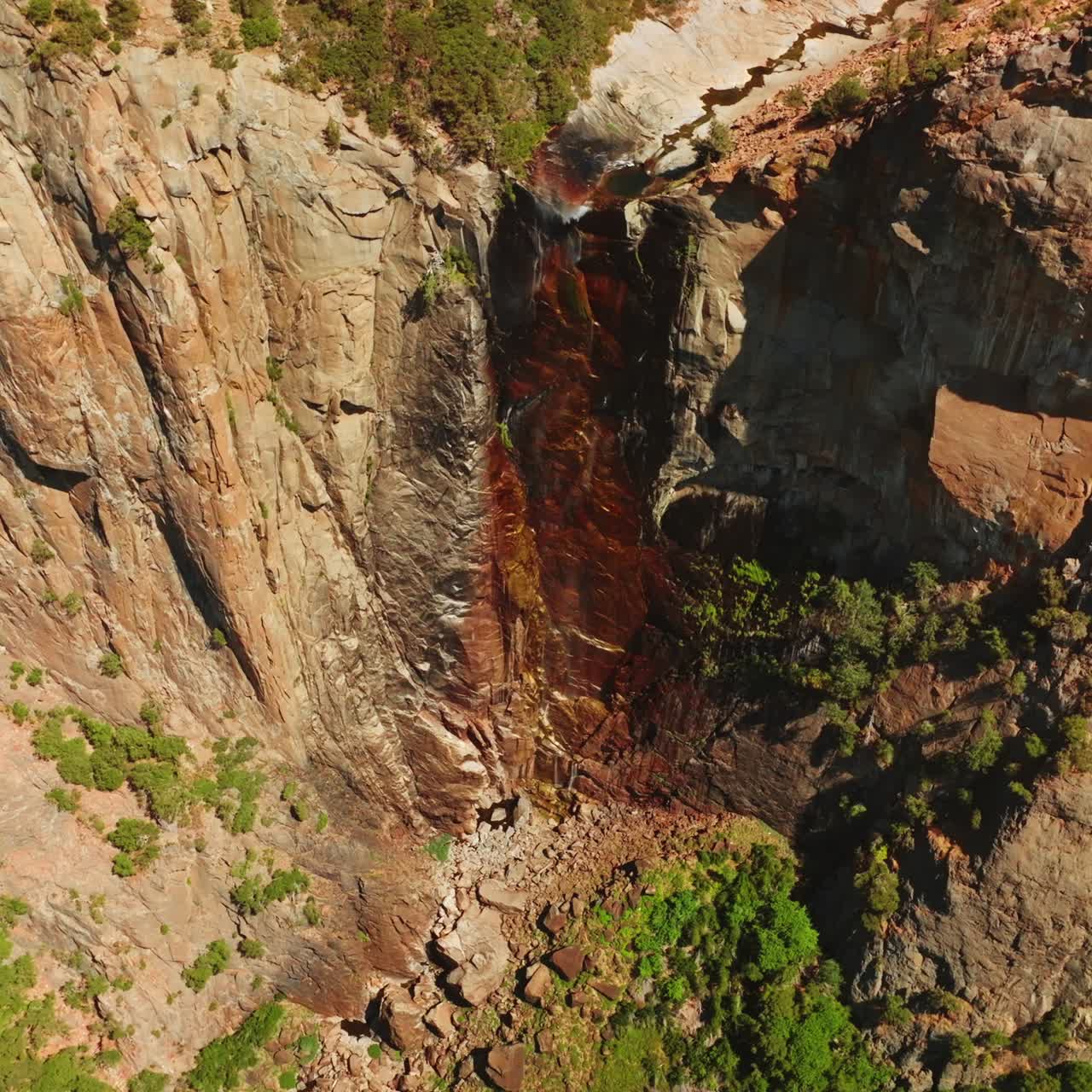 Dried waterfall in Yosemite National Park, California, USA. Steep cliffs with some vegetation on. View from top