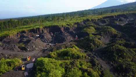 orbit drone shot of illegal sand mining activities that cause environmental damage on the slope of mountain