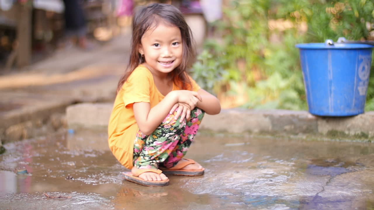 Smiling Girl in a Puddle