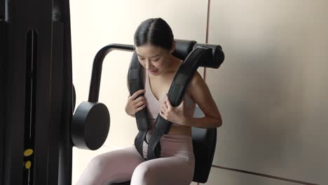 woman working out on gym equipment