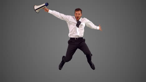 businessman holding megaphone and jumping up on grey background