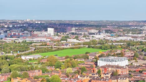 Aerial-footage-of-the-Leeds-centre-of-Headingley,-the-footage-shows-the-town-centre-in-the-background-with-roads-and-traffic,-taken-on-a-beautiful-sunny-day