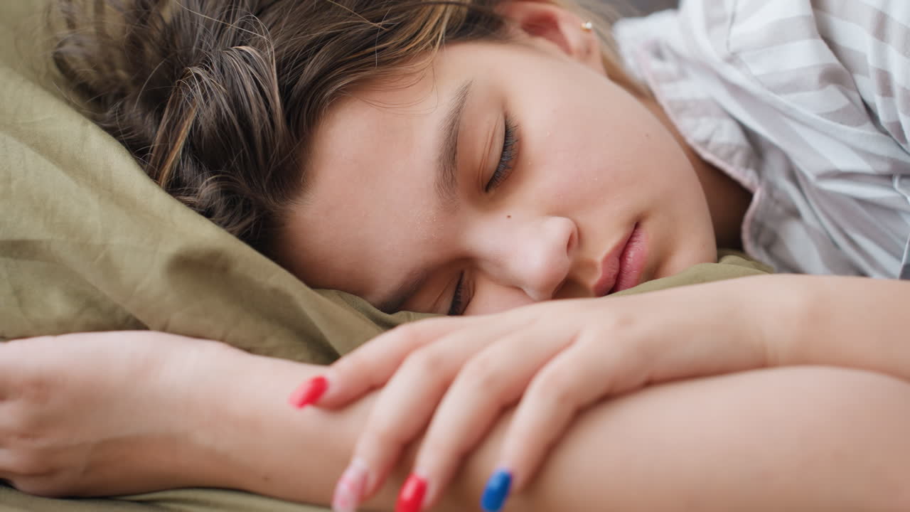Peaceful Woman Resting Comfortably, Relaxed Figure With Shiny Nails Sleeps On Colorful Soft Bedding, Serene Beauty Resting Peacefully On Vibrant Bed With Polished Nails And Relaxed Posture