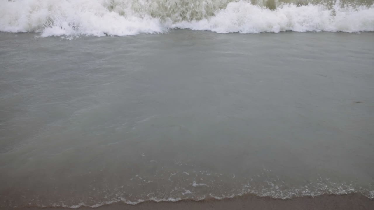Foamy Sea Waves On Sandy Shore Of Tropical Beach. - close up shot