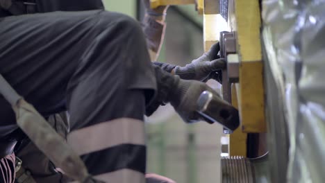 worker hitting striking wrench with hammer, slow motion closeup