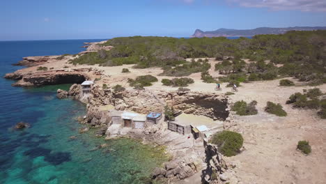 exploring the breathtaking beach in ibiza on mountain bike, drone aerial