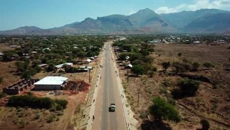 endless road along moroto countryside town with mountain background in karamoja, uganda, east africa