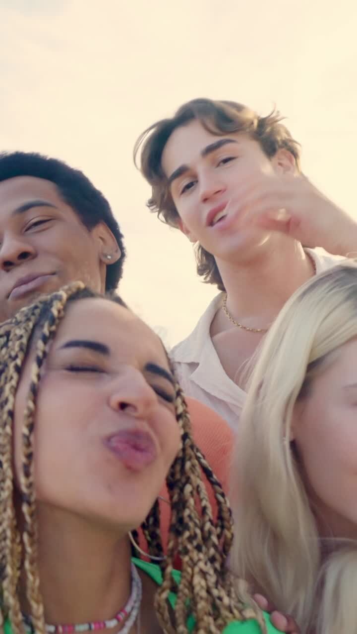 Happy latin woman taking selfie with multi-ethnic friends outdoors