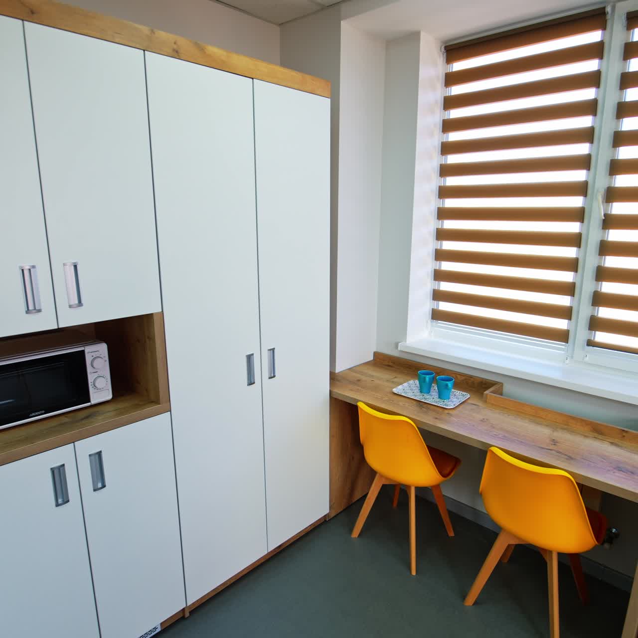 Two blue cups on the table in the ward for people who have just become parents. Maternity care ward in modern clinic for newly born kids and their mothers