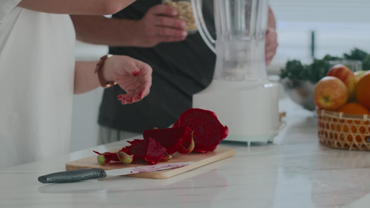Hands of Unrecognizable Person Preparing Healthy Breakfast with Dragon Fruit