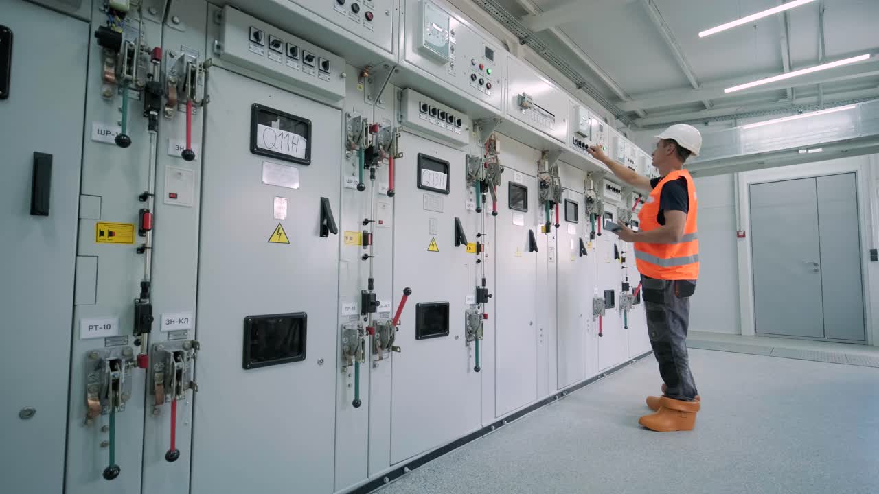 los ingenieros eléctricos inspeccionan los sistemas eléctricos en el gabinete de control de equipos
