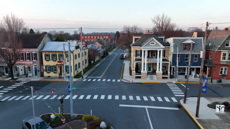 rising aerial reveals homes along street in small town america