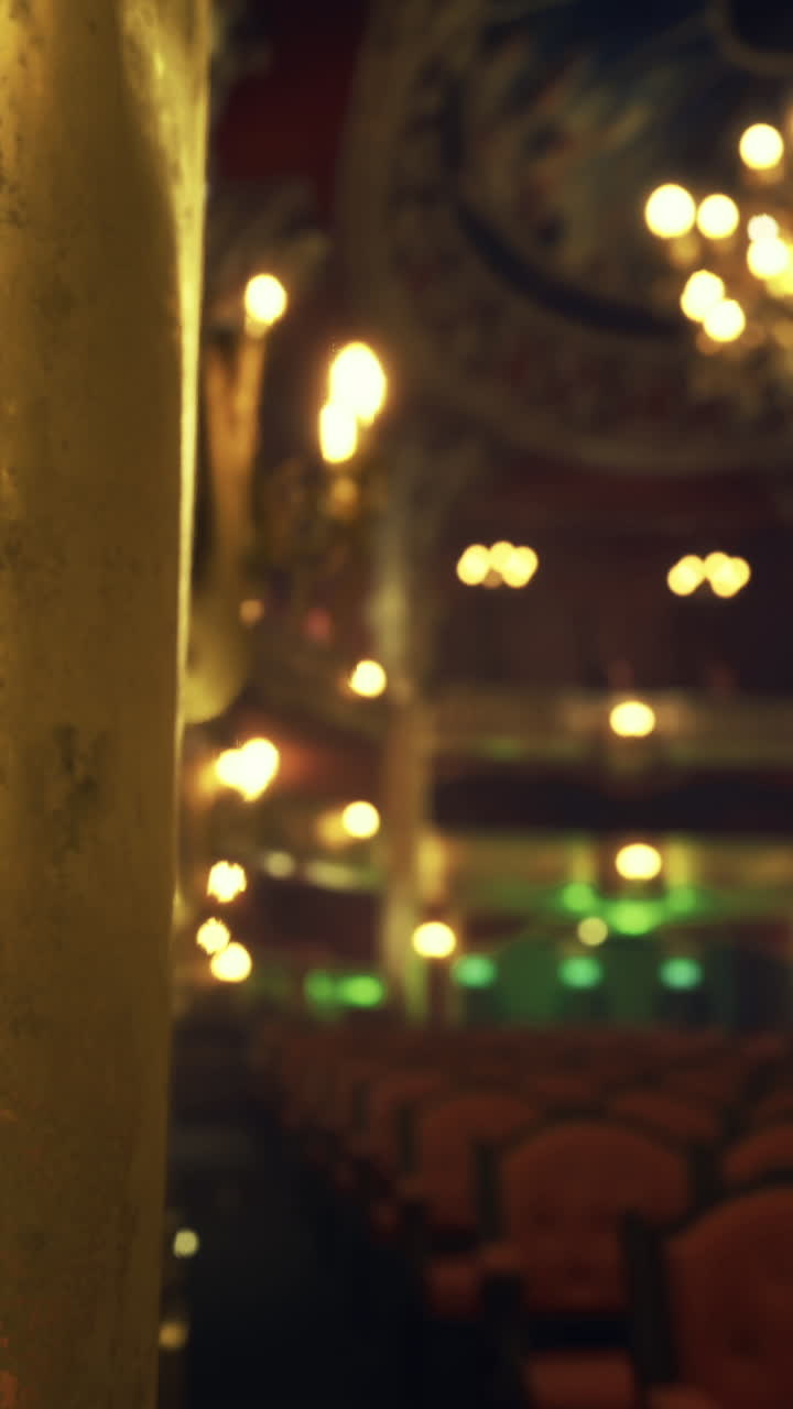 Elegant interior of a historic theater with ornate lighting and seating