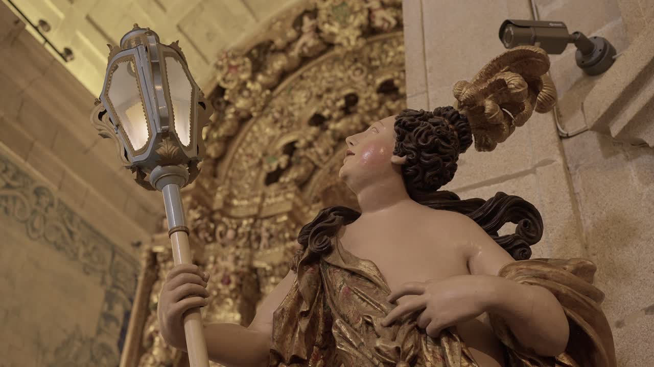 Close up of an intricate Baroque statue holding a lantern inside a historic church